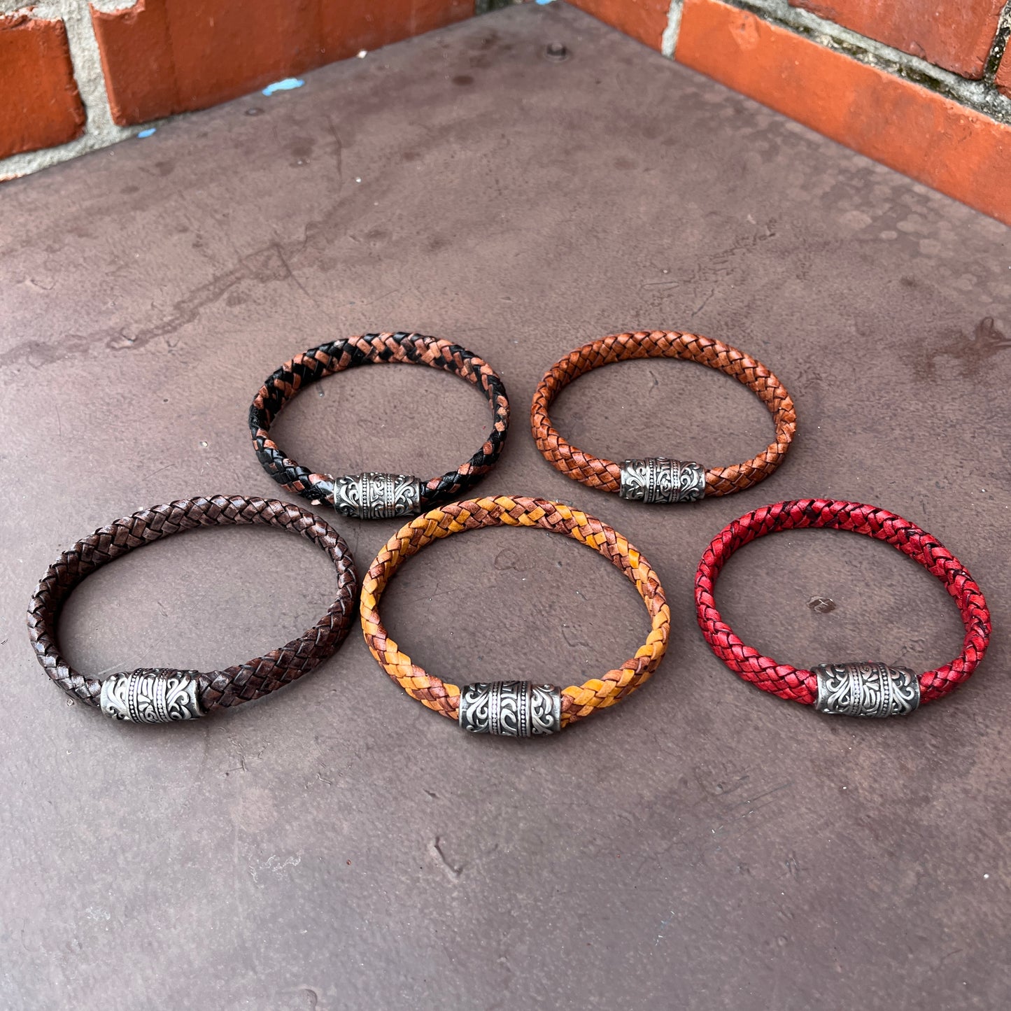 BRAIDED FLAT LEATHER BRACELET WITH STAINLESS STEEL TRIBAL MAGNET CLASP