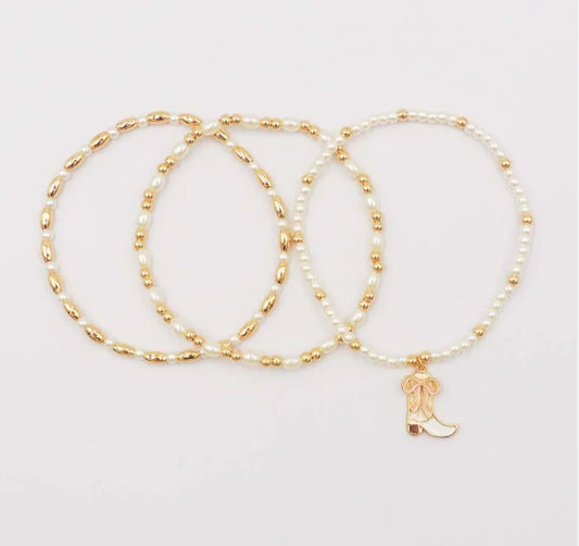 Set of Three Gold and Pearl Stretch Bracelets with Light Pink Bow on White Cowboy Boot Charm
